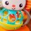 Sonoro Musical Bright Starts Grab & Giggle Monkey com Mais de 20 Sons e Luminoso